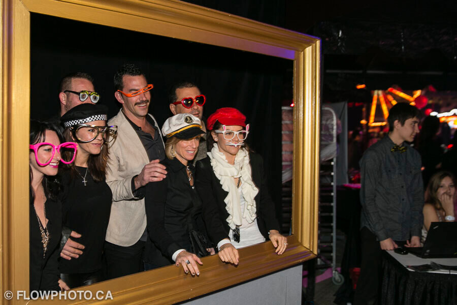 guests posing in a giant frame photo booth