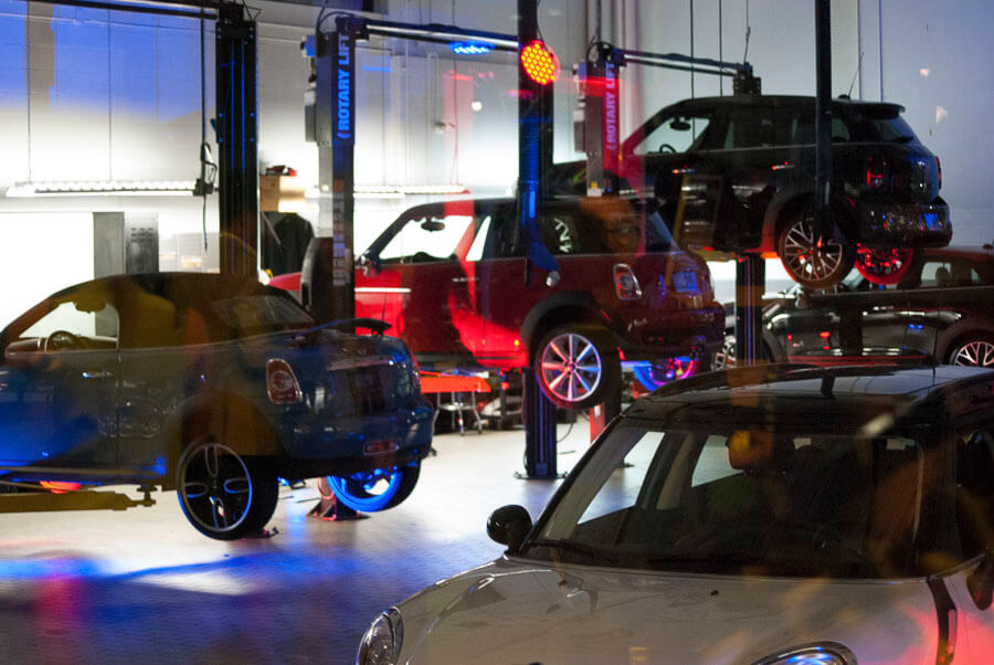 Mini coopers in a garage on display