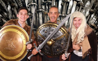 three men posing with medieval swords and shields