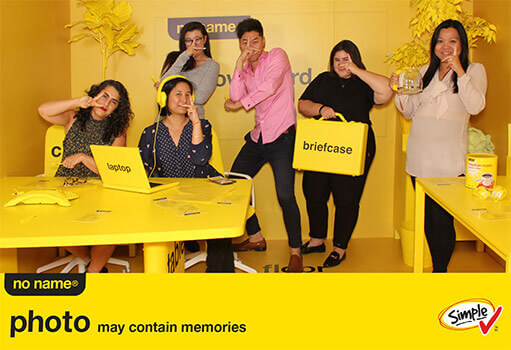 People posing on an all yellow set