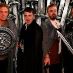 Four men posing while wearing games of thrones costumes