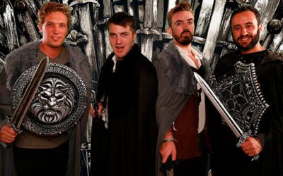 Four men posing while wearing games of thrones costumes