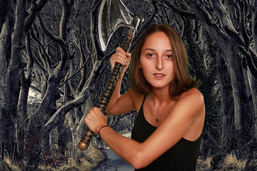 Green screen image of a woman in the forest with an axe