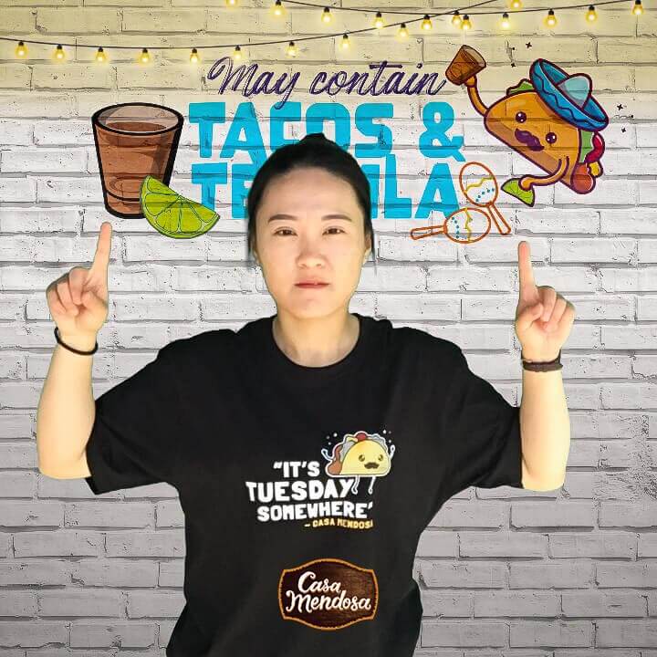 A woman posing at a taco and tequila event