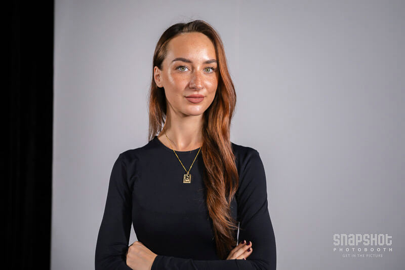 a woman posing in a headshot photo booth