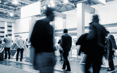 A hero image of a busy trade show exhibition floor